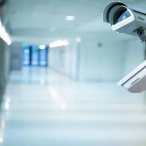 Two white color security camera at a corridor