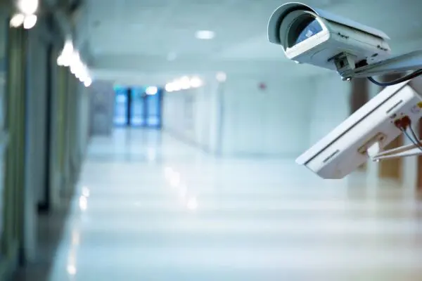 Two white color security camera at a corridor