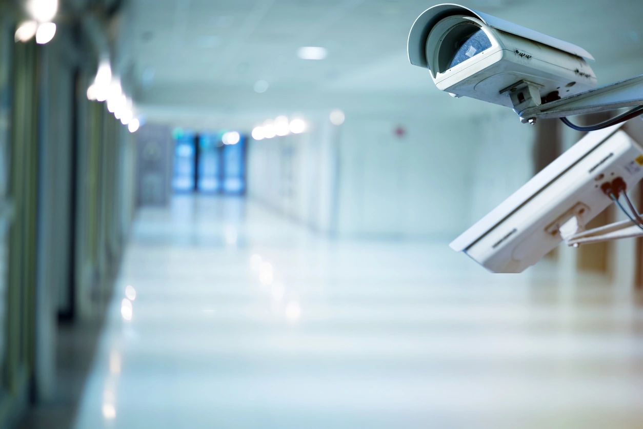 Two white color security camera at a corridor