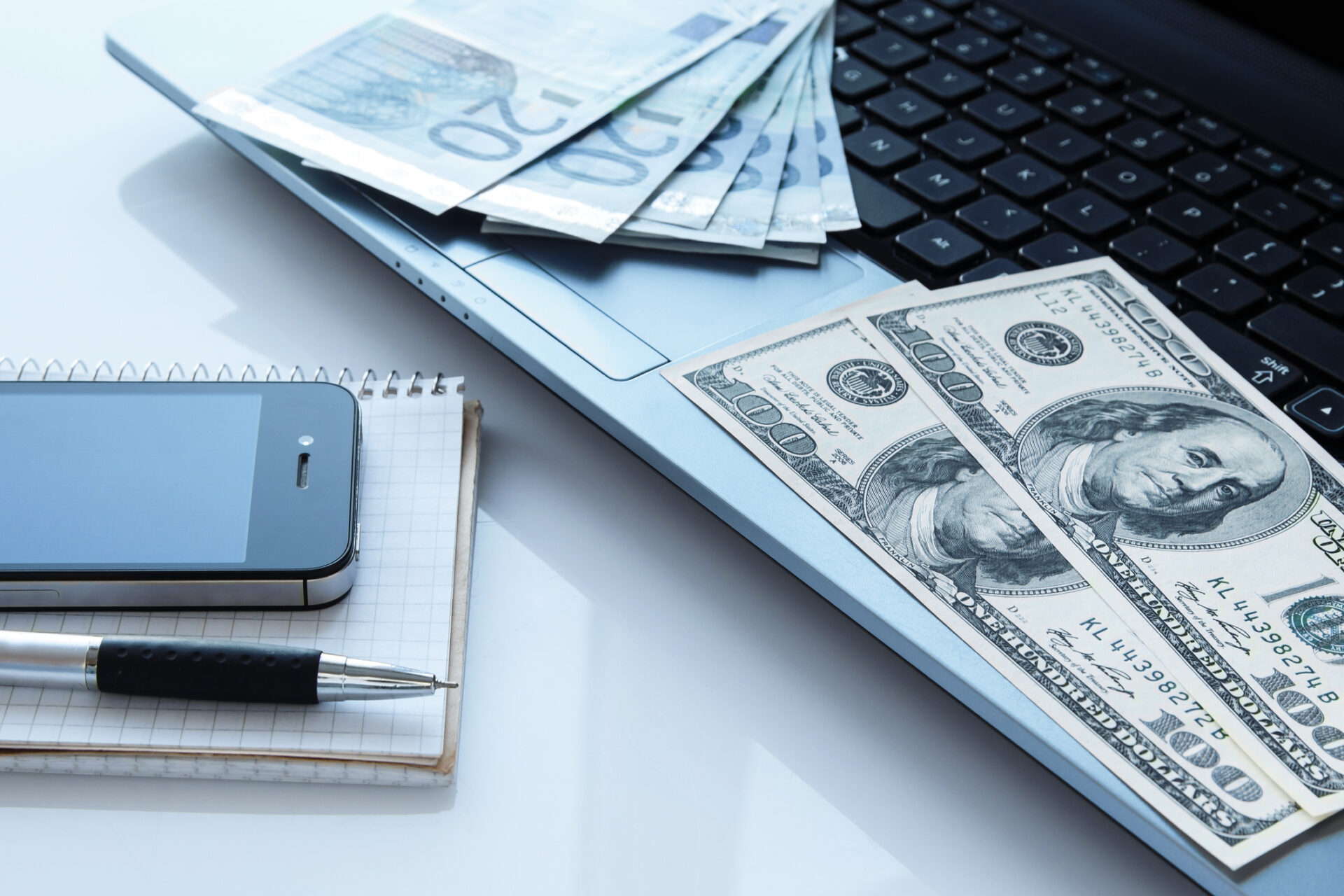 Workplace with money and electronic devices