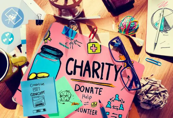 A charity poster on a table along with other accessories