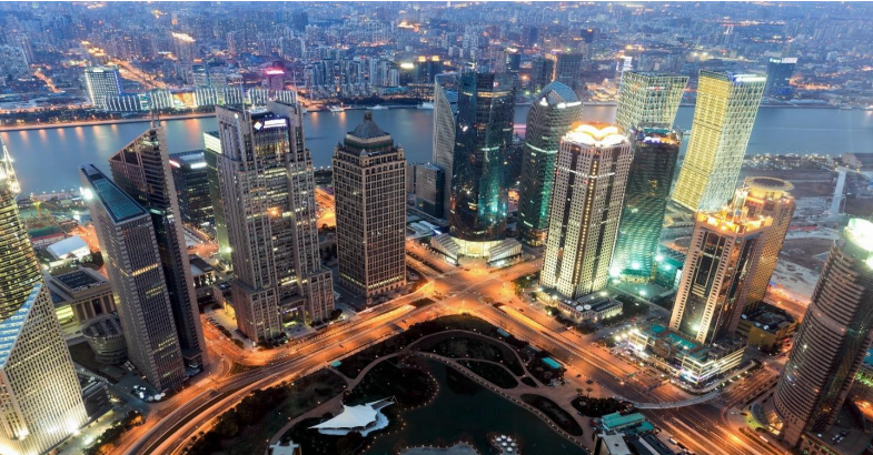 Aerial view of illuminated skyscrapers at night.