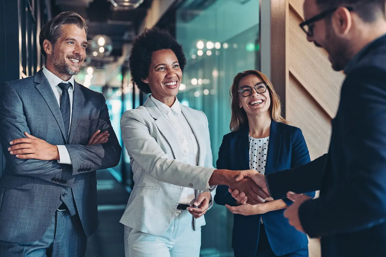 Business colleagues shaking hands in an office.