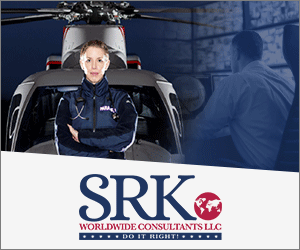 A woman in uniform sitting on top of an airplane.