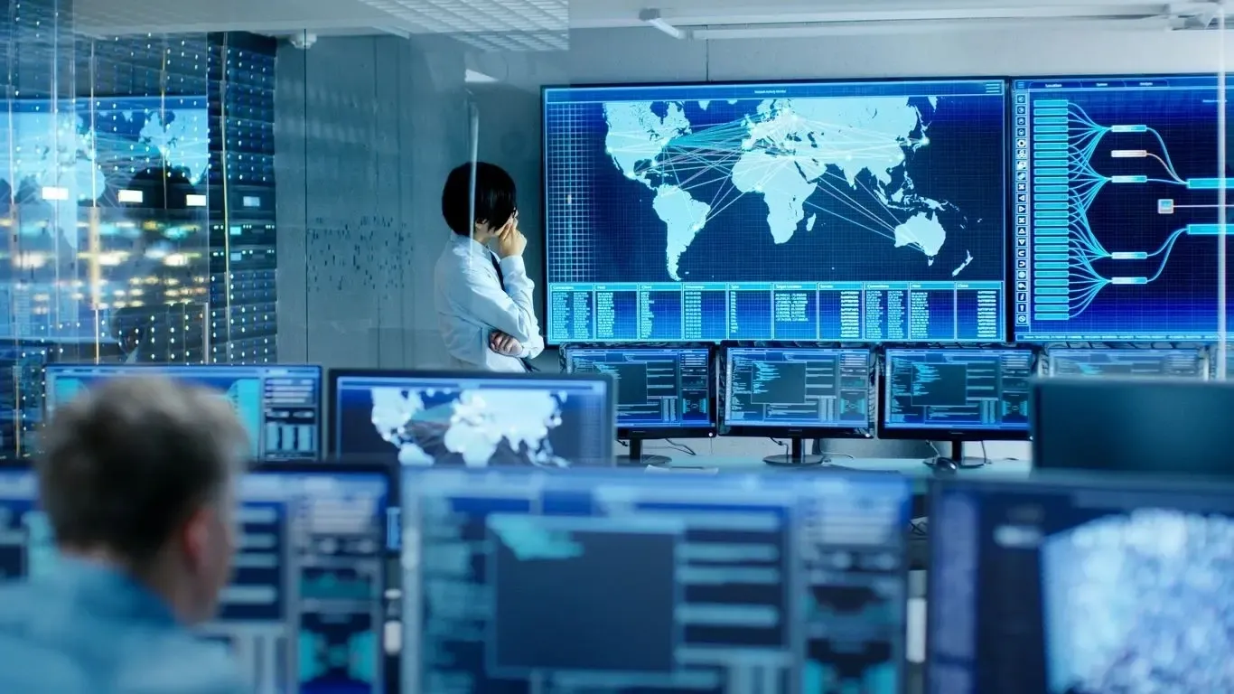 Control room with multiple computer screens.