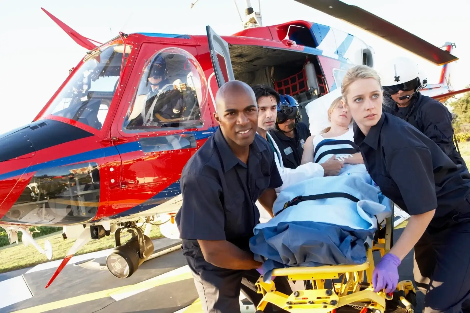 Paramedics transport patient by helicopter stretcher.
