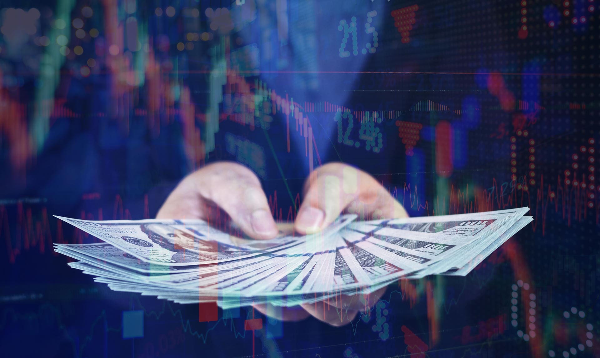 Hands holding money with stock market background.